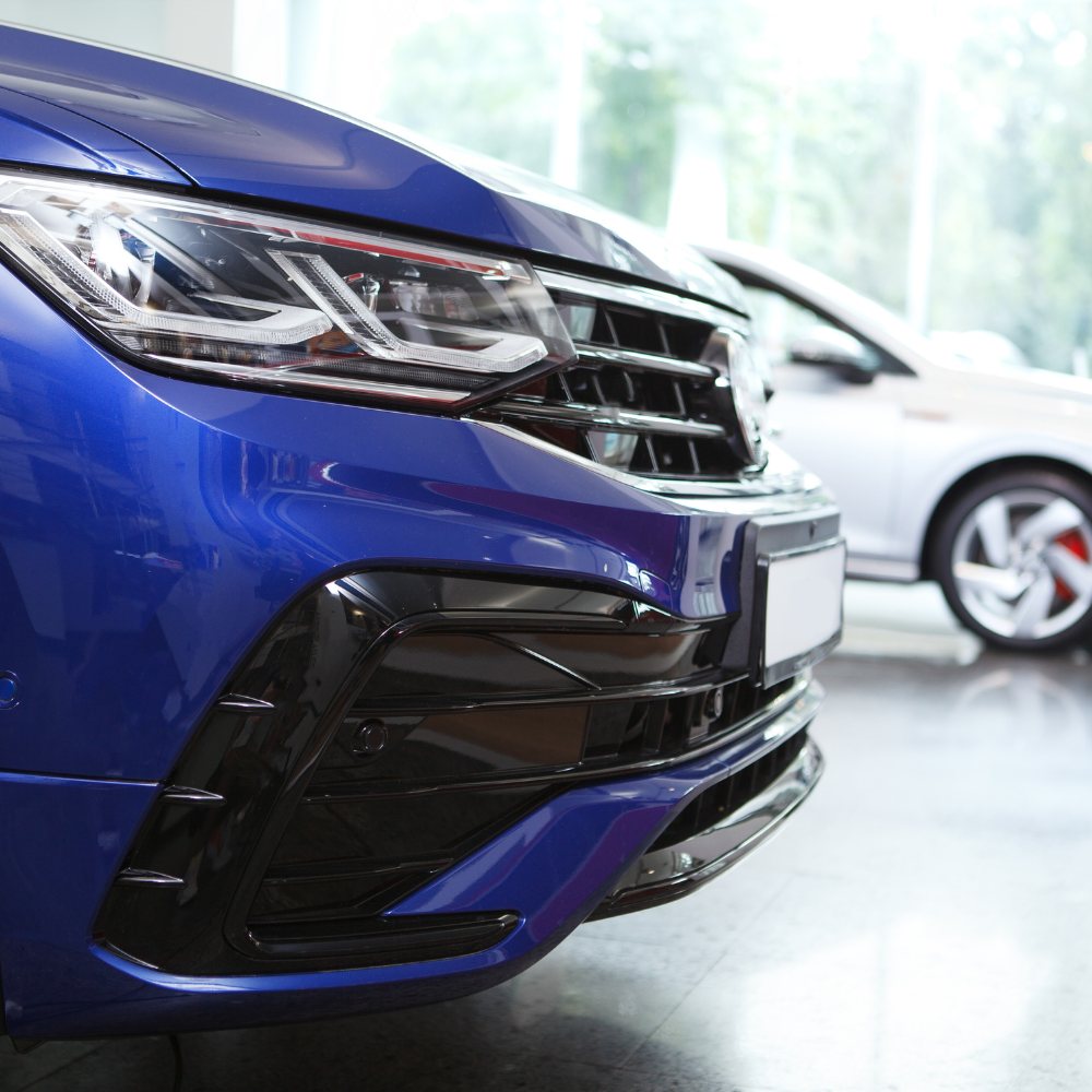 Front of a blue car in a showroom